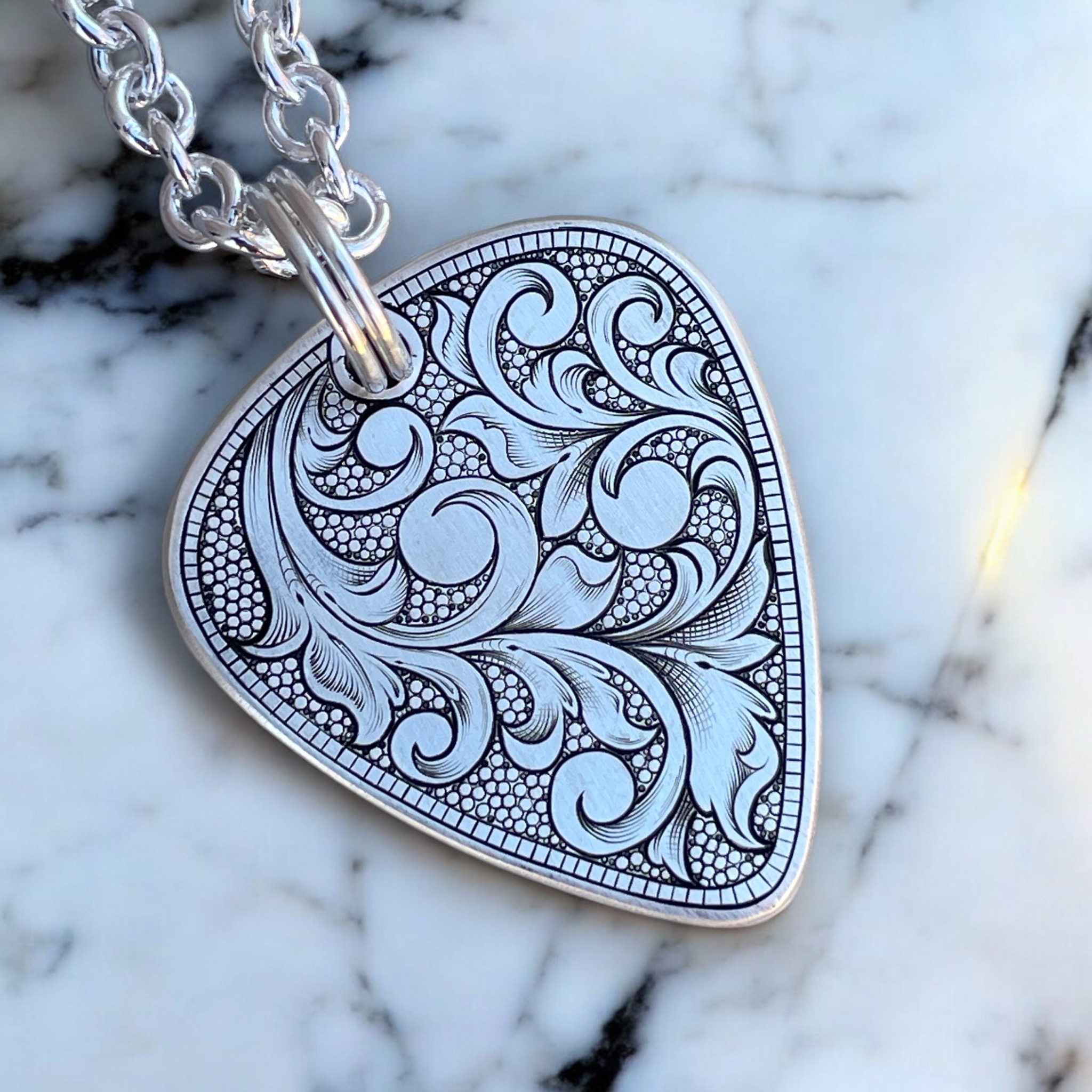 Hand Engraved Guitar Pick Pendant - Scrolls - Left Angle